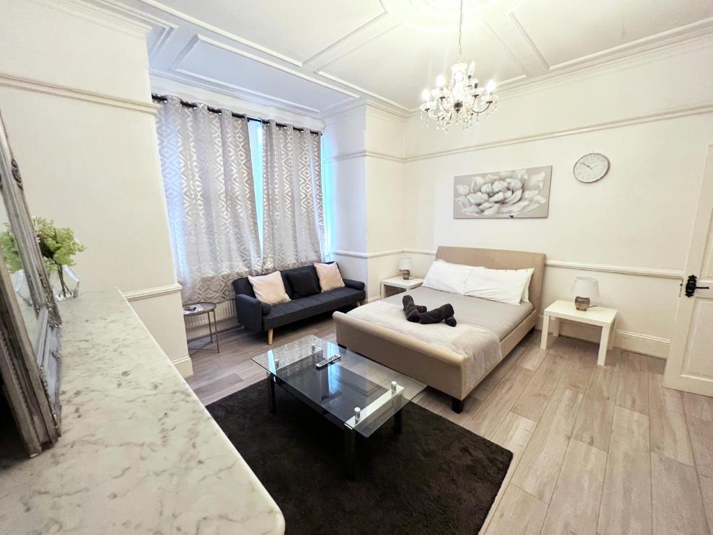 a living room with a couch and a table at Norbury House - Apartment 1A in Norbury