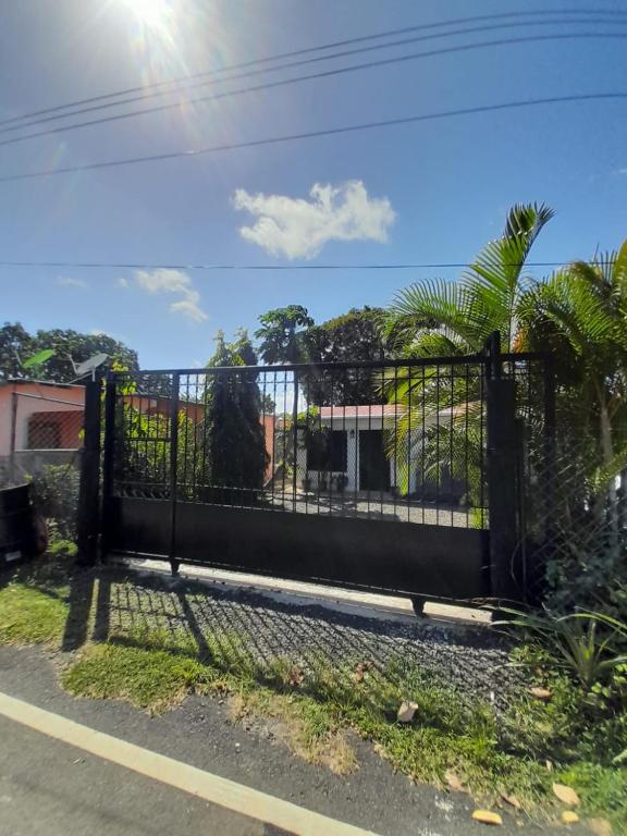 a black gate on the side of a road at CASA HARPIA in Pedasí Town