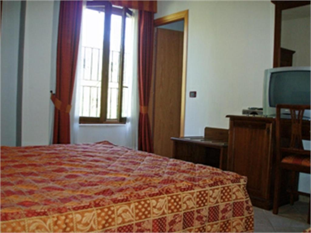 Posteľ alebo postele v izbe v ubytovaní Hotel Bellagio