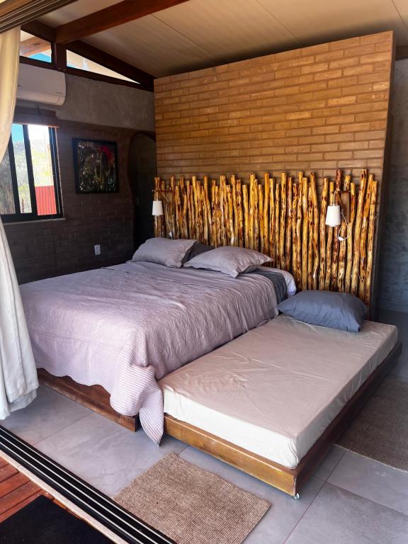 two beds sitting next to each other in a bedroom at Sertão do Luar in Jurubeba