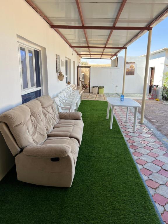 a living room with a couch and a table at Big dune camp in Ḩawīyah