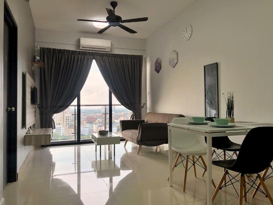 a living room with a ceiling fan and a table and chairs at JC Sky Riverfront 'Pebble' w/Fantastic River View in Kota Bharu