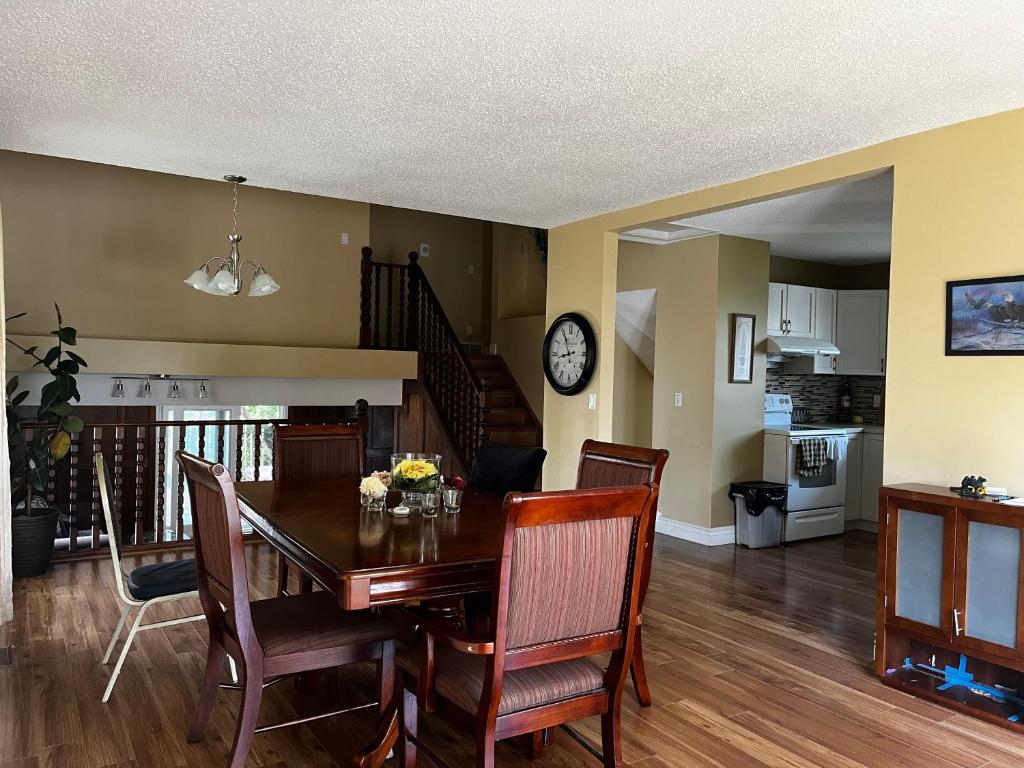 a kitchen and dining room with a table and chairs at Beddington masteroom close airport! in Calgary
