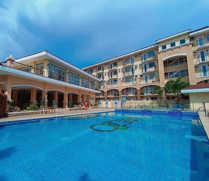a large swimming pool in front of a hotel at Arezzo Place Davao Condominium in Davao City