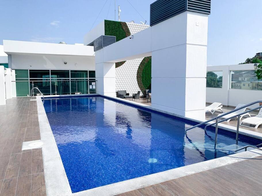 a swimming pool on the roof of a building at Hermosa Suite con vista al rio! Piscina y Parqueo in Guayaquil