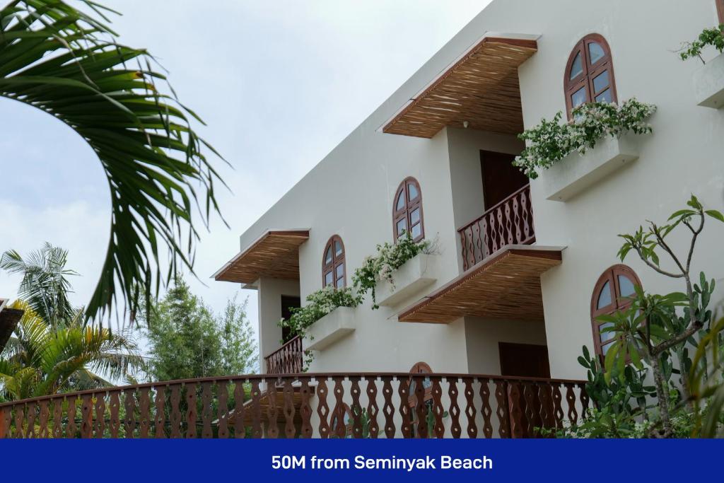 un edificio con balcones y plantas. en Kresna By The Sea By Kresna Hospitality, en Seminyak