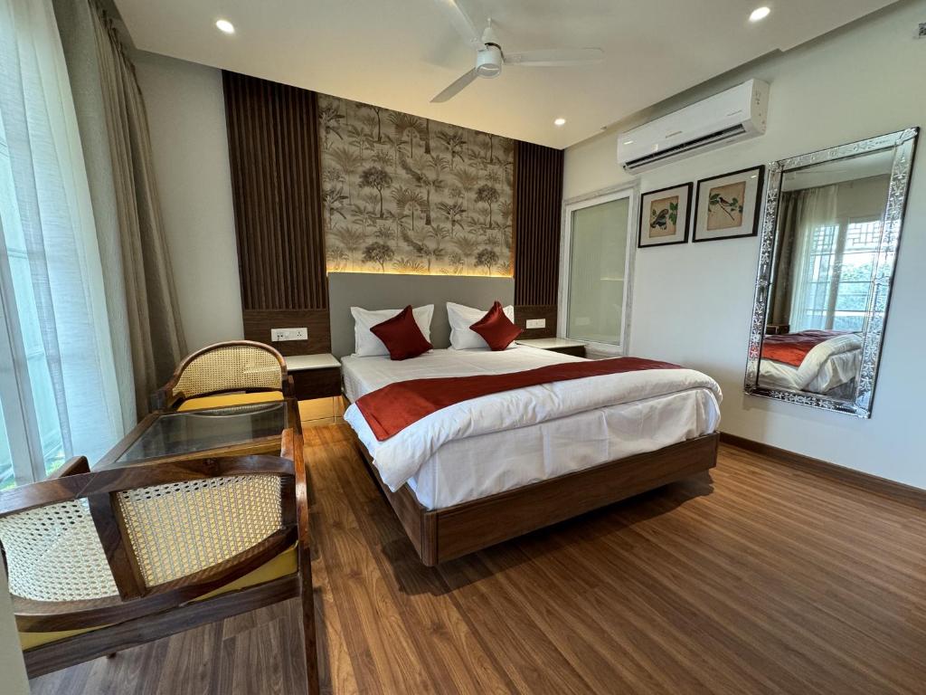 a hotel room with a bed and a window at Sky Suites By The Lazy Host in Udaipur