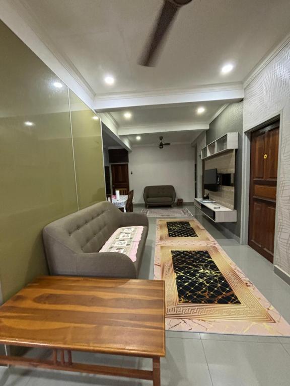a living room with a couch and a table at Embun Selasih Homestay in Pasir Gudang
