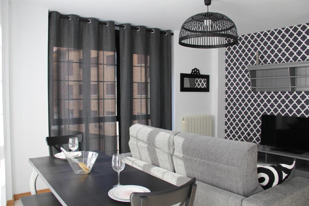 una sala de estar con un sofá y una mesa en Apartamentos Vino y Camino, en Nájera