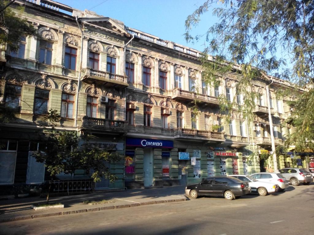 a large building with cars parked in front of it at Appartment Grecheskaya 45/40 in Odesa