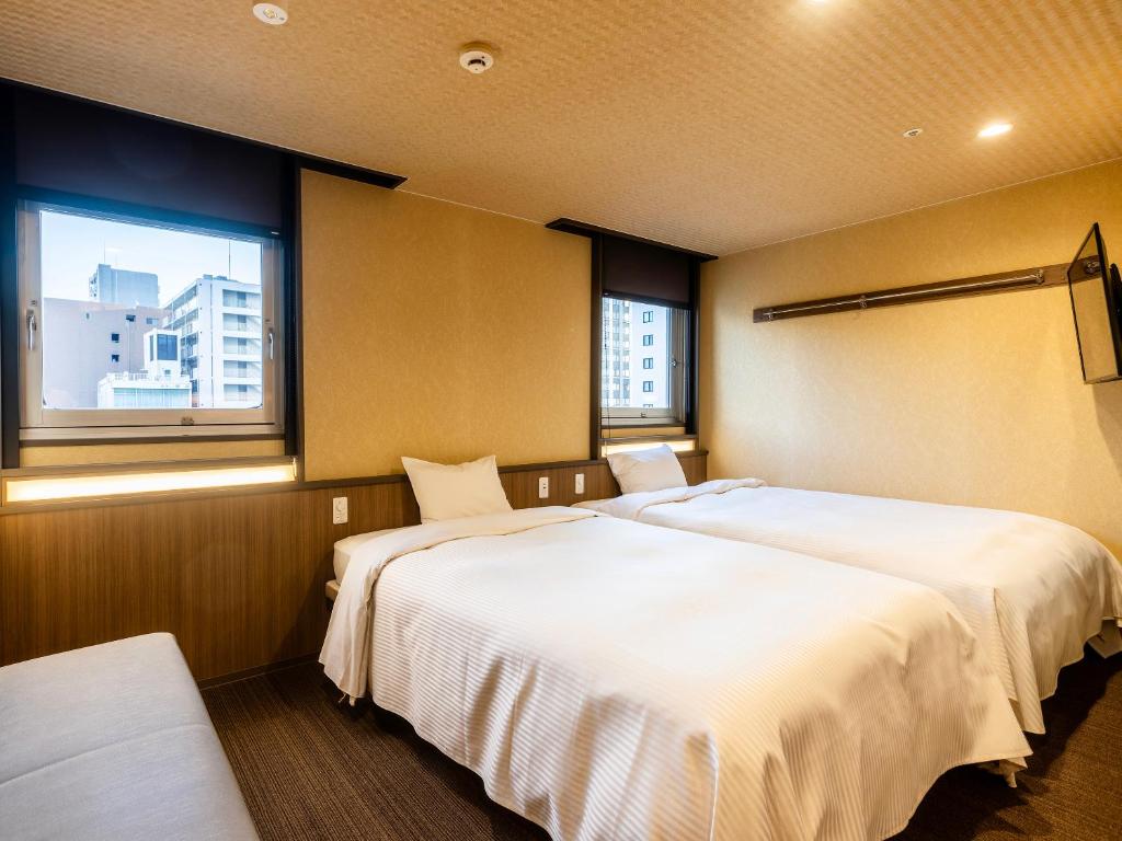 Postel nebo postele na pokoji v ubytování Nagoya Crown Hotel