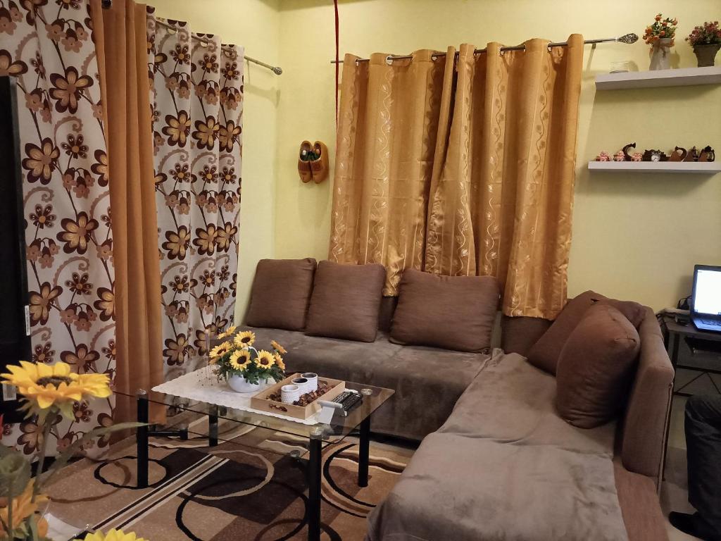 a living room with a couch and a table at Regina Vacation House in Tayud
