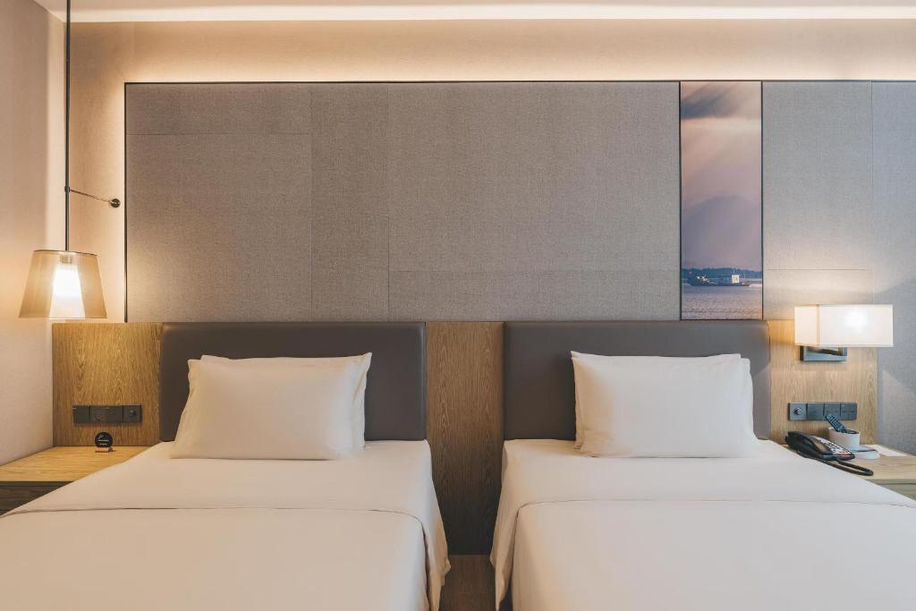 Postel nebo postele na pokoji v ubytování Atour Hotel Shenzhen Xili Innovation Valley