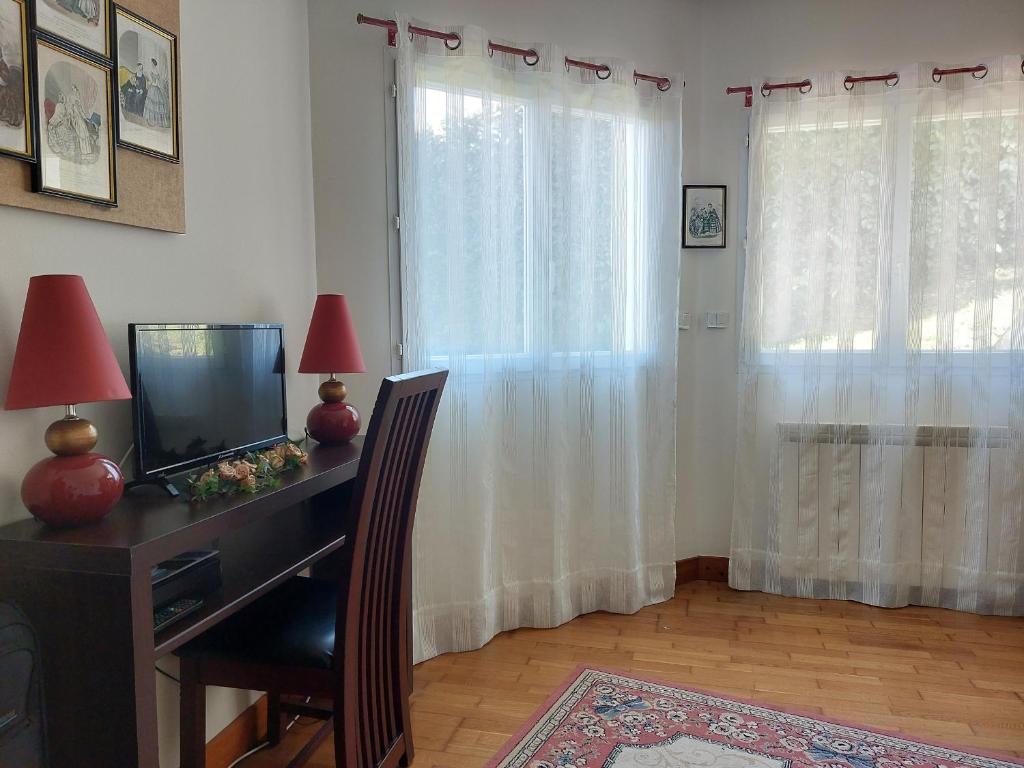 a room with a desk with a television and a window at Appartement Urrugne, 3 pièces, 6 personnes - FR-1-239-772 in Urrugne