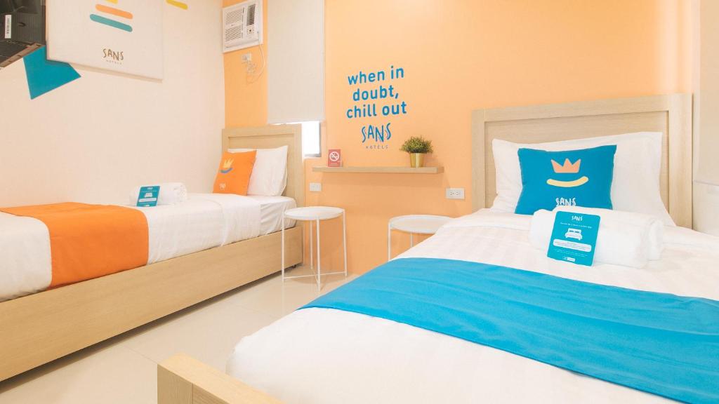 Postel nebo postele na pokoji v ubytování Sans Hotel at One JD Place Makati by RedDoorz