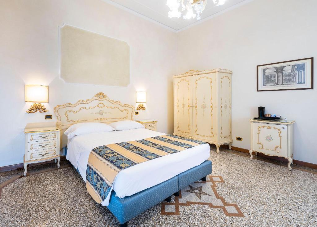 a bedroom with a large bed and two night stands at Hotel Torino in Venice