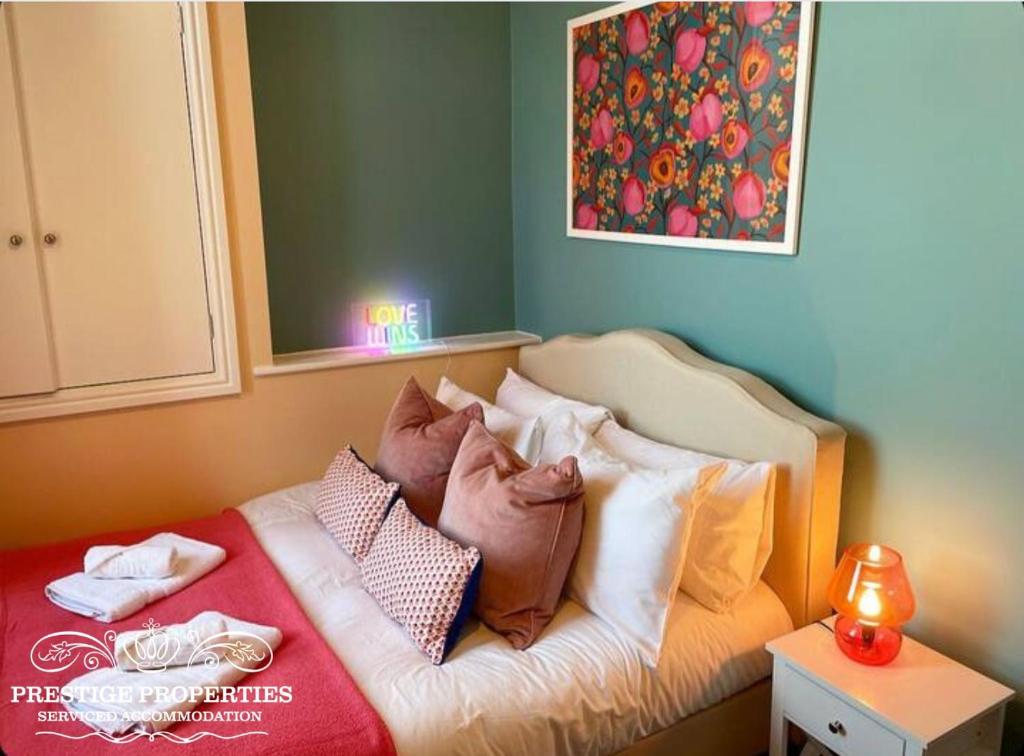 a bedroom with a bed with pillows on it at Apartment 1 West County by Prestige Properties SA in Millom