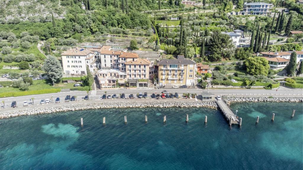 an aerial view of a resort with a dock in the water at Lake Sensation - Garda Lake View in Nago-Torbole
