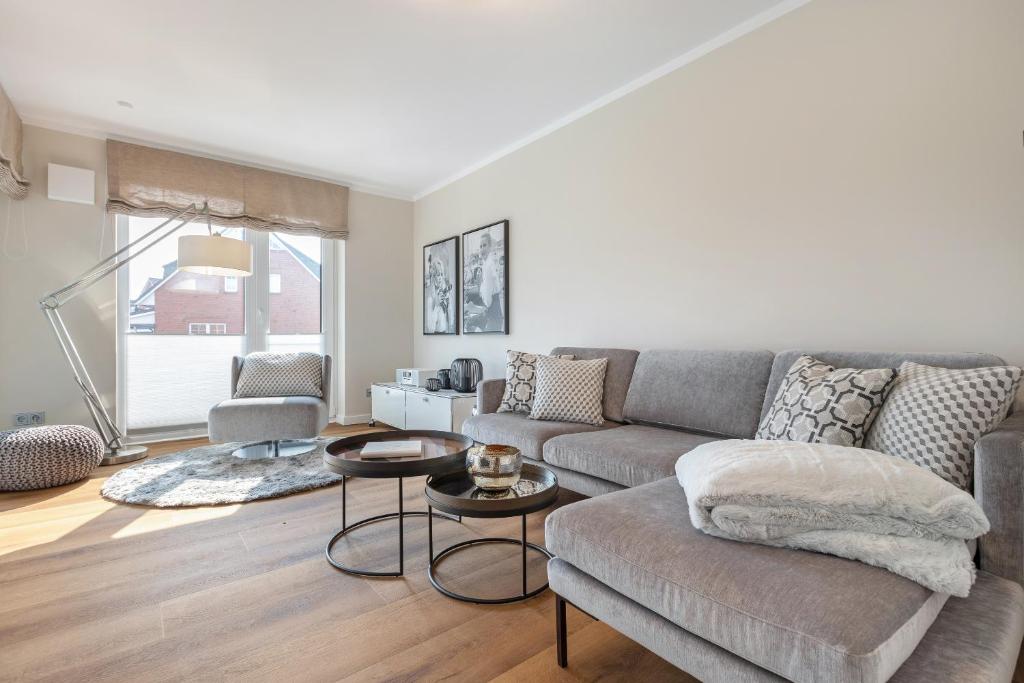 a living room with a couch and a table at Seekristall in List
