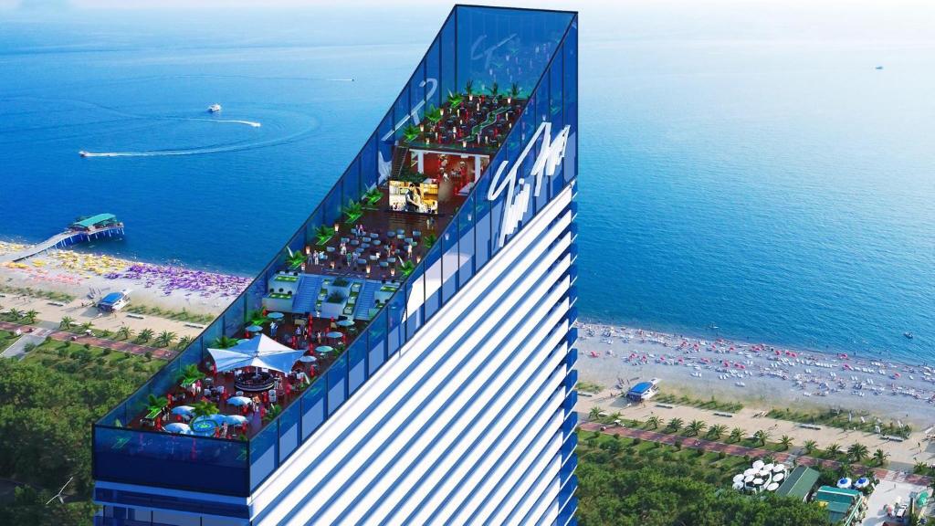 a building on a beach next to the ocean at Orbi City Premium Apartments in Batumi