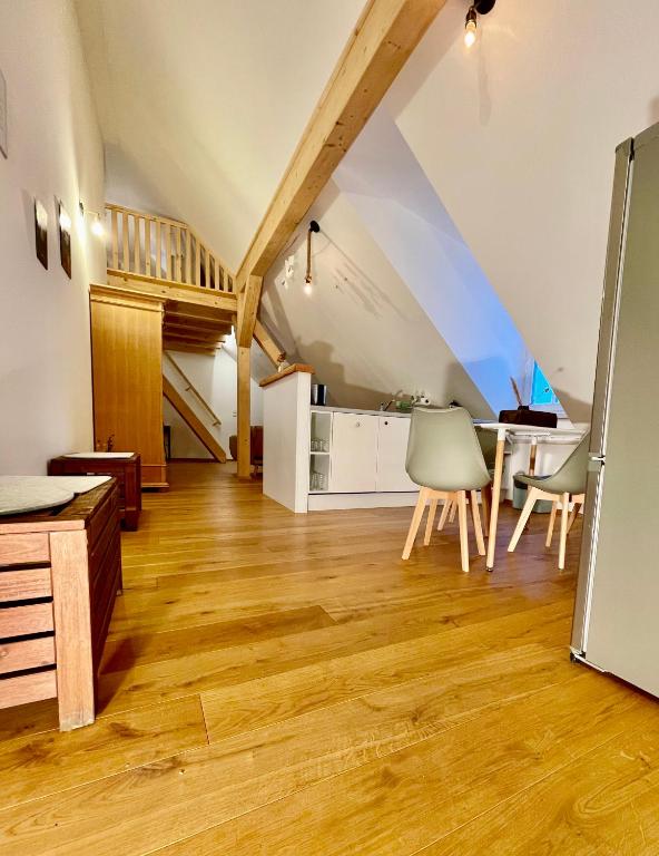 an attic living room with a table and chairs at Destino in Sulzbach-Rosenberg