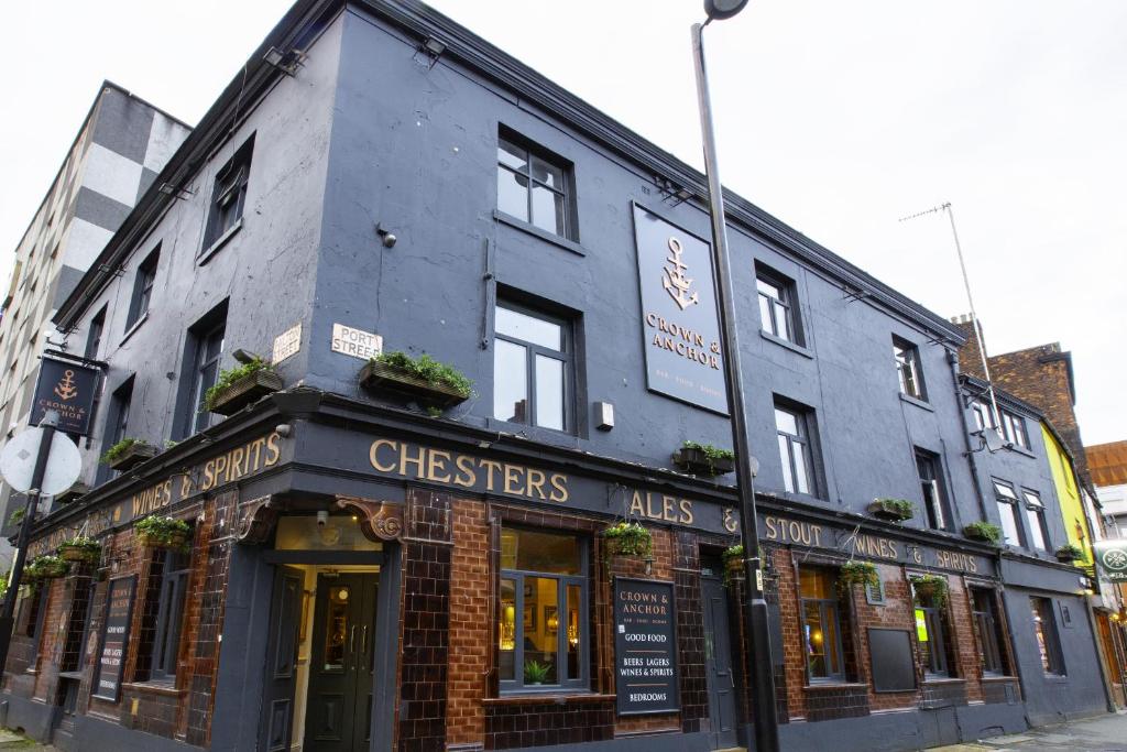 a building on the corner of a street at The Crown & Anchor in Manchester