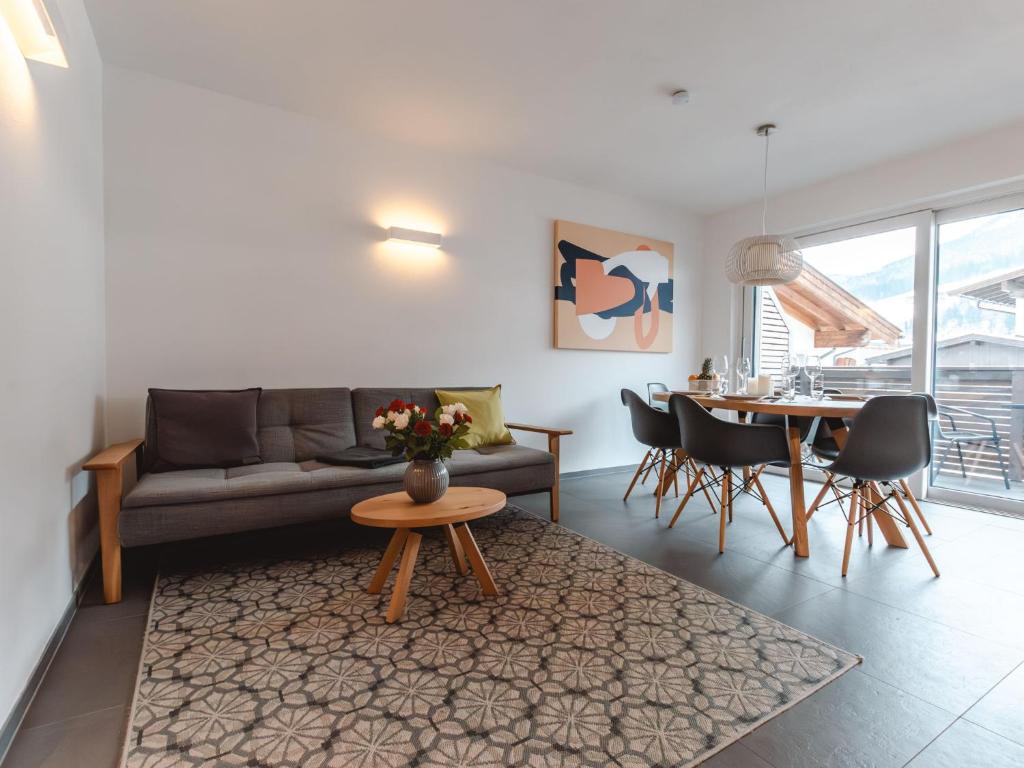 a living room with a couch and a table at Apartment Das Georgen- Schmitten by Interhome in Fürstau