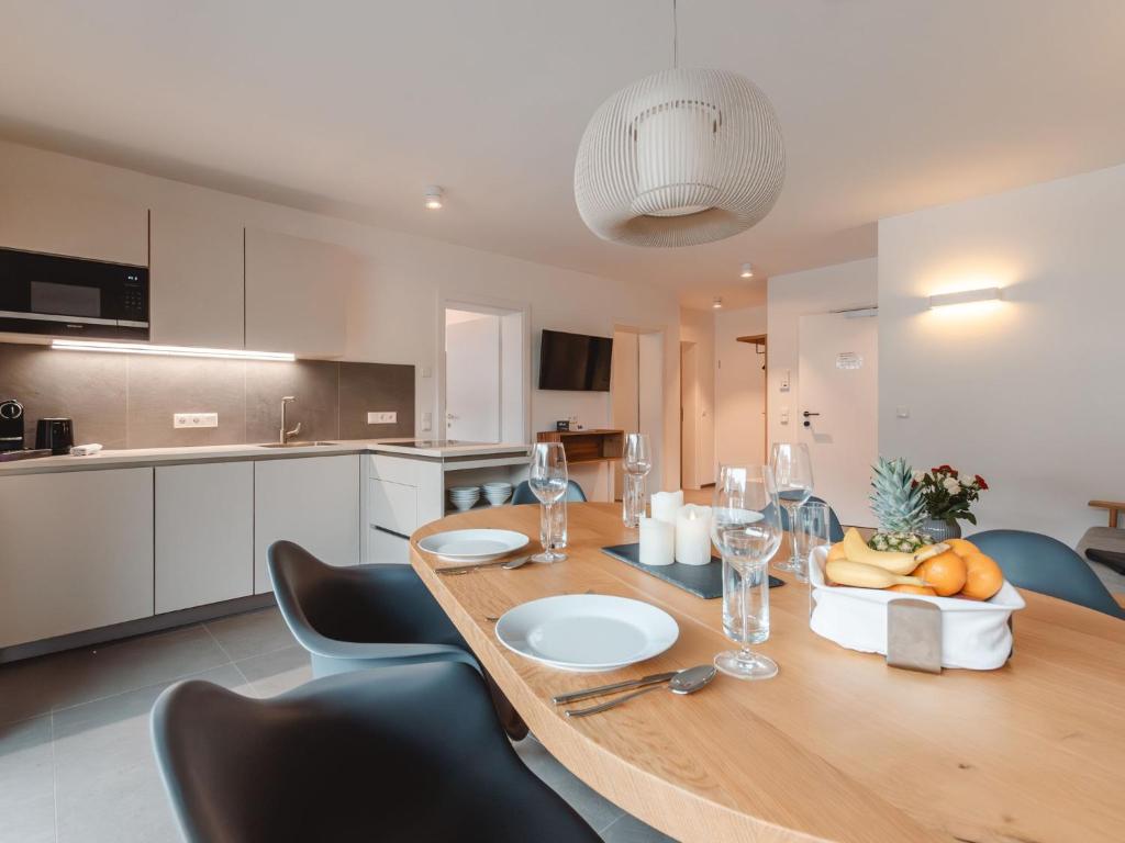 a dining room table with a bowl of fruit and wine glasses at Apartment Das Georgen- Schmitten by Interhome in Fürstau