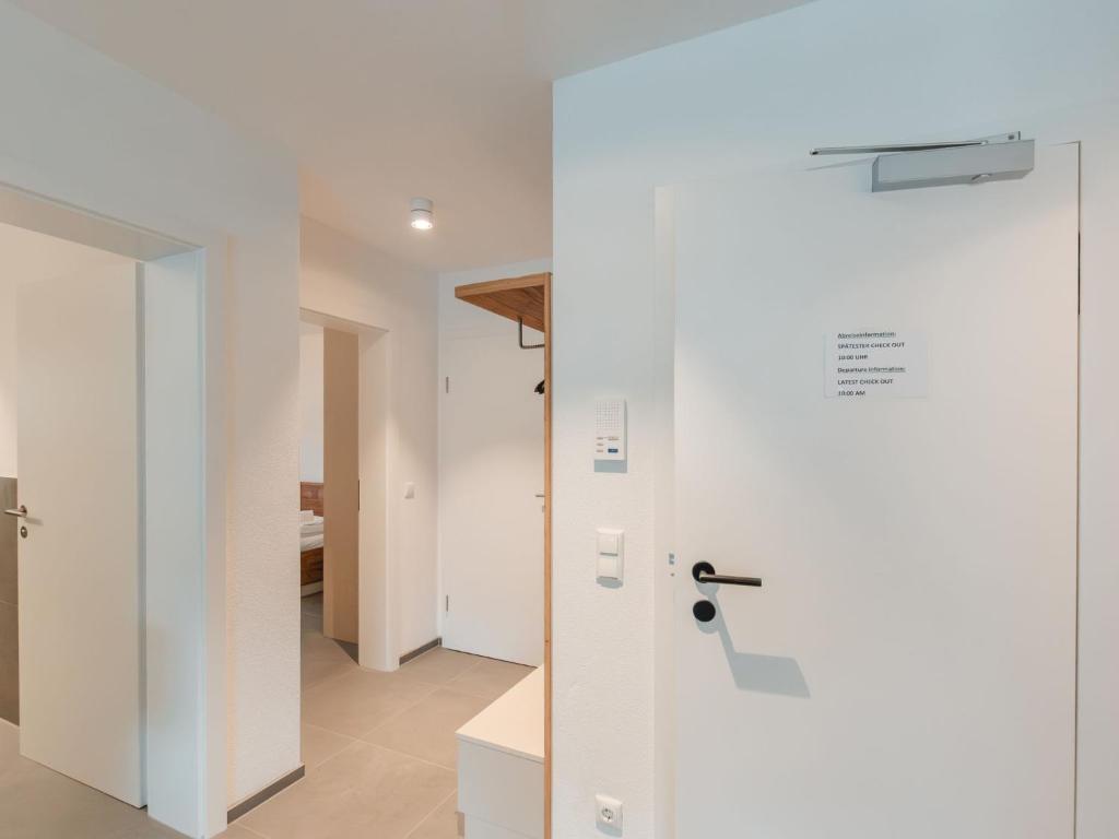 a door in a room with a white wall at Apartment Das Georgen- Schmitten by Interhome in Fürstau