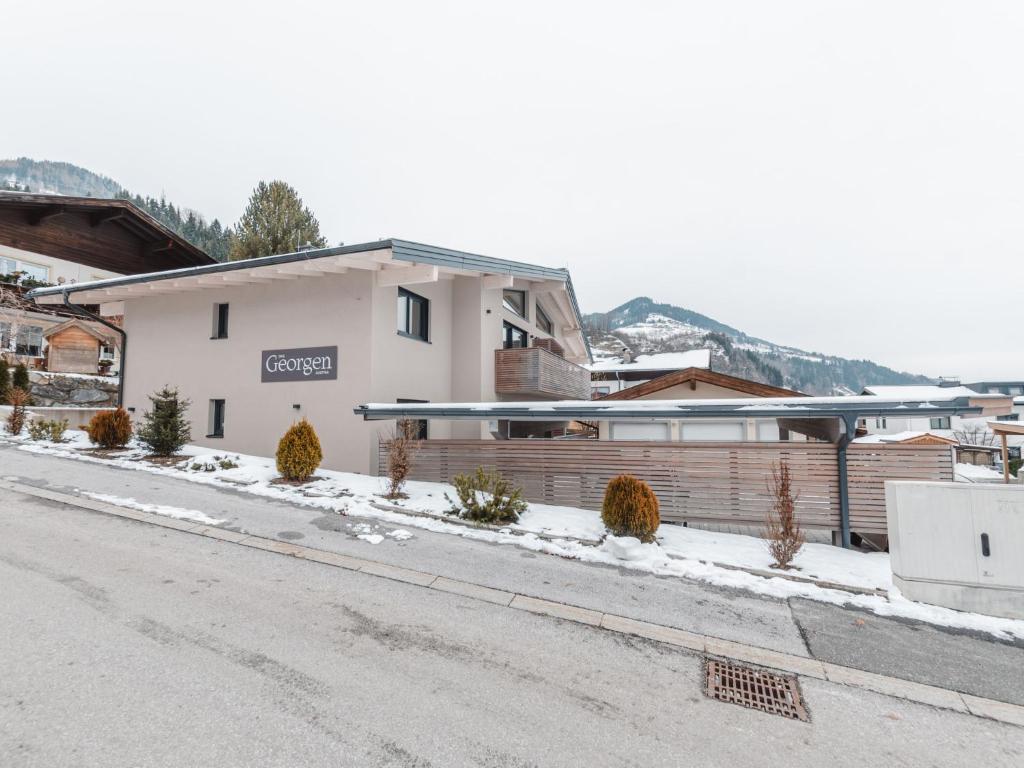 a building on the side of a snowy street at Apartment Das Georgen- Schmitten by Interhome in Fürstau