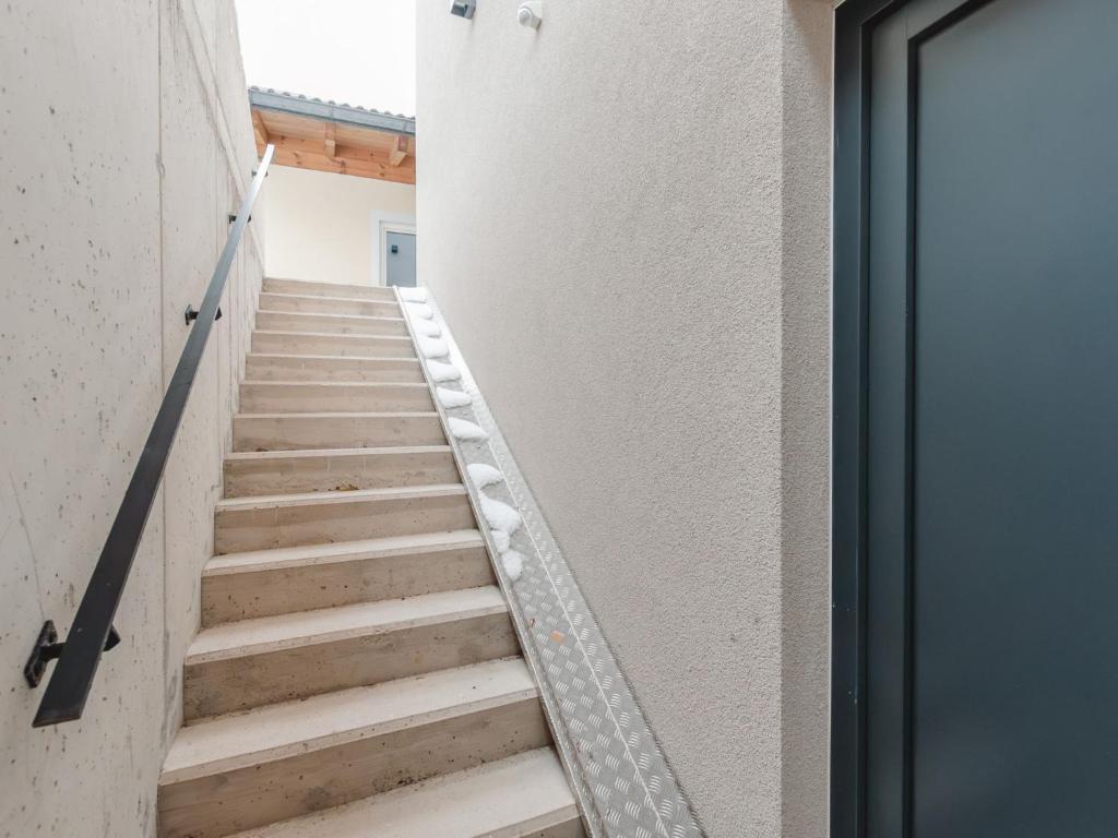 a staircase in a room with a door at Apartment Das Georgen- Schmitten by Interhome in Fürstau