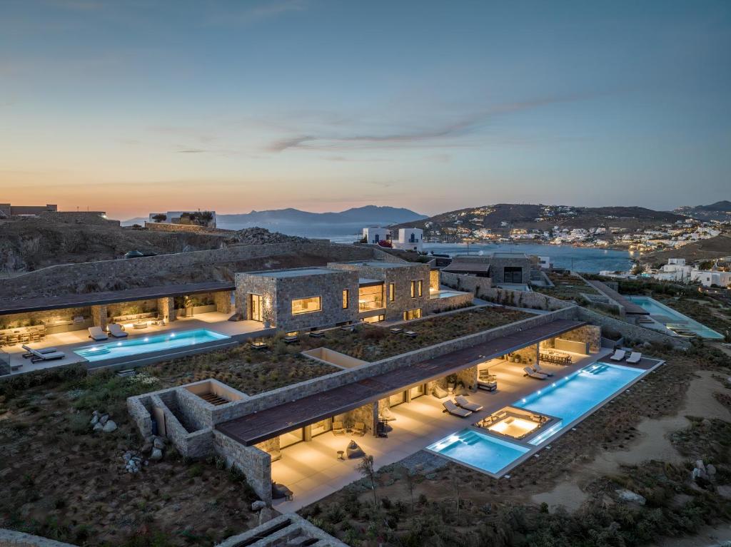 an aerial view of a building with two swimming pools at Apollo Yard Villa in Mikonos
