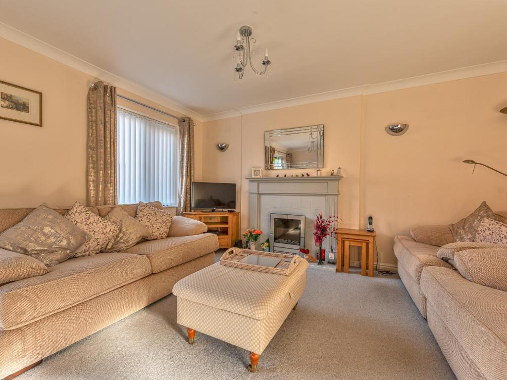 a living room with a couch and a fireplace at Lovely Detached Home Pass The Keys in Telford