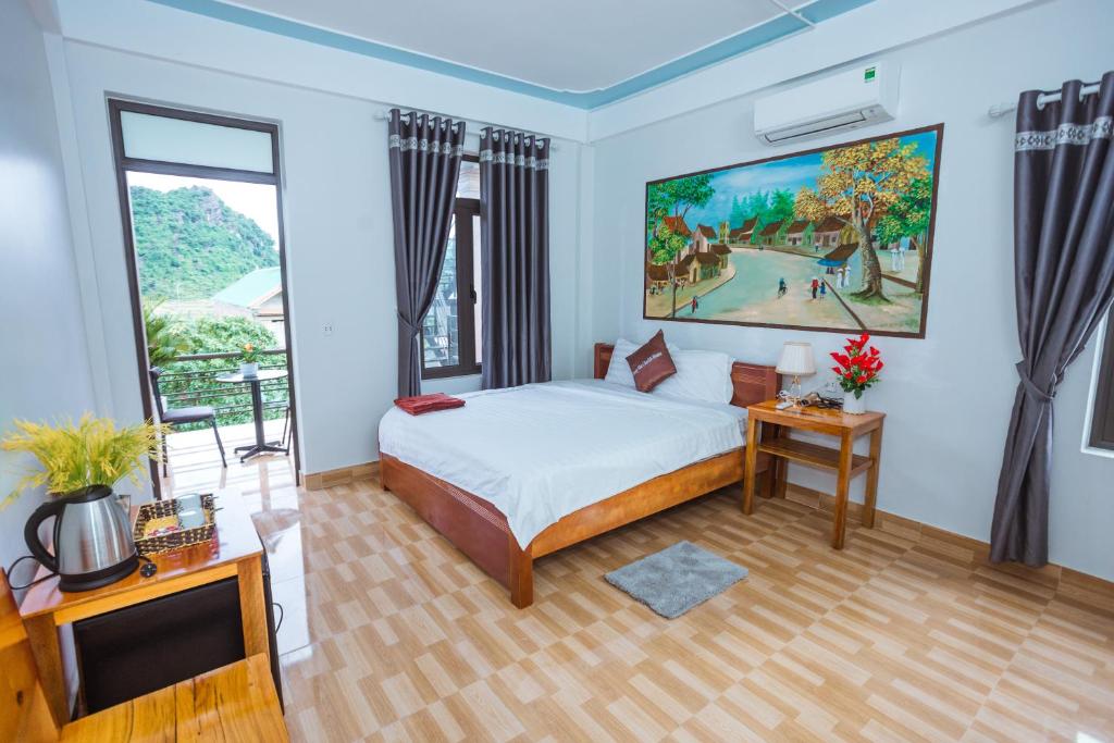 a bedroom with a bed and a large window at Phong Nha Cherish House in Phong Nha