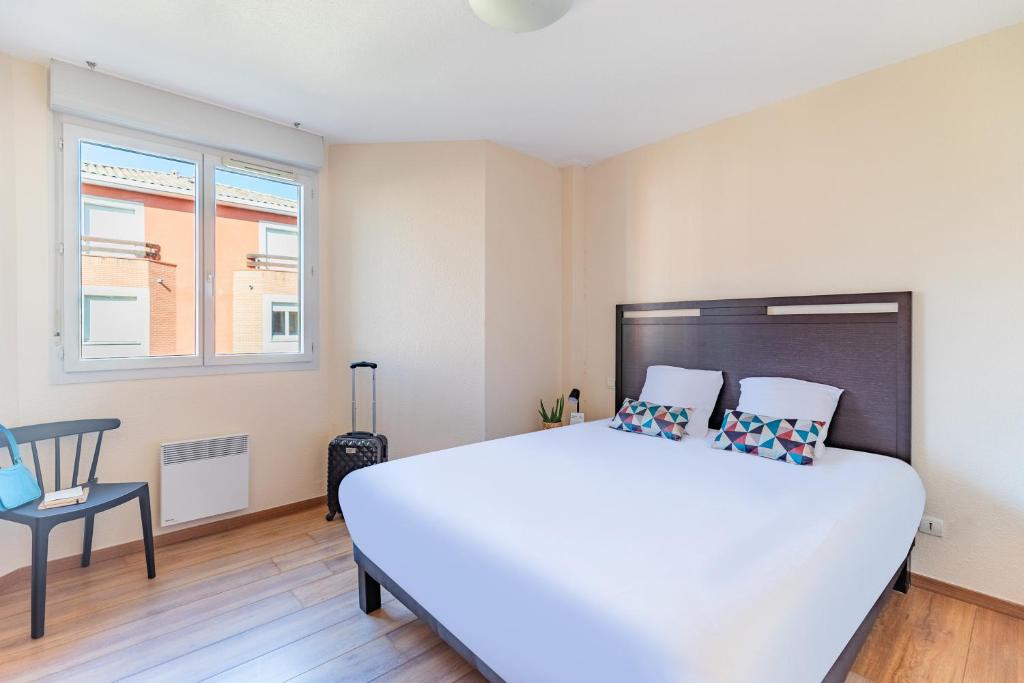 Letto o letti in una camera di Appart'City Classic Toulouse Saint-Simon