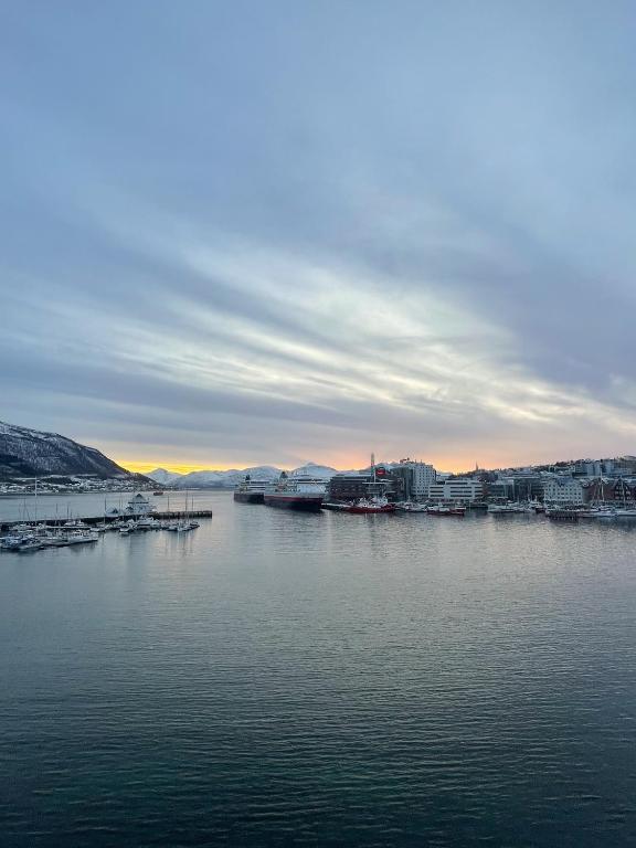 a view of a large body of water with buildings at Northstay - The Northview Retreat, Free Parking, Amazing Ocean Views in Tromsø