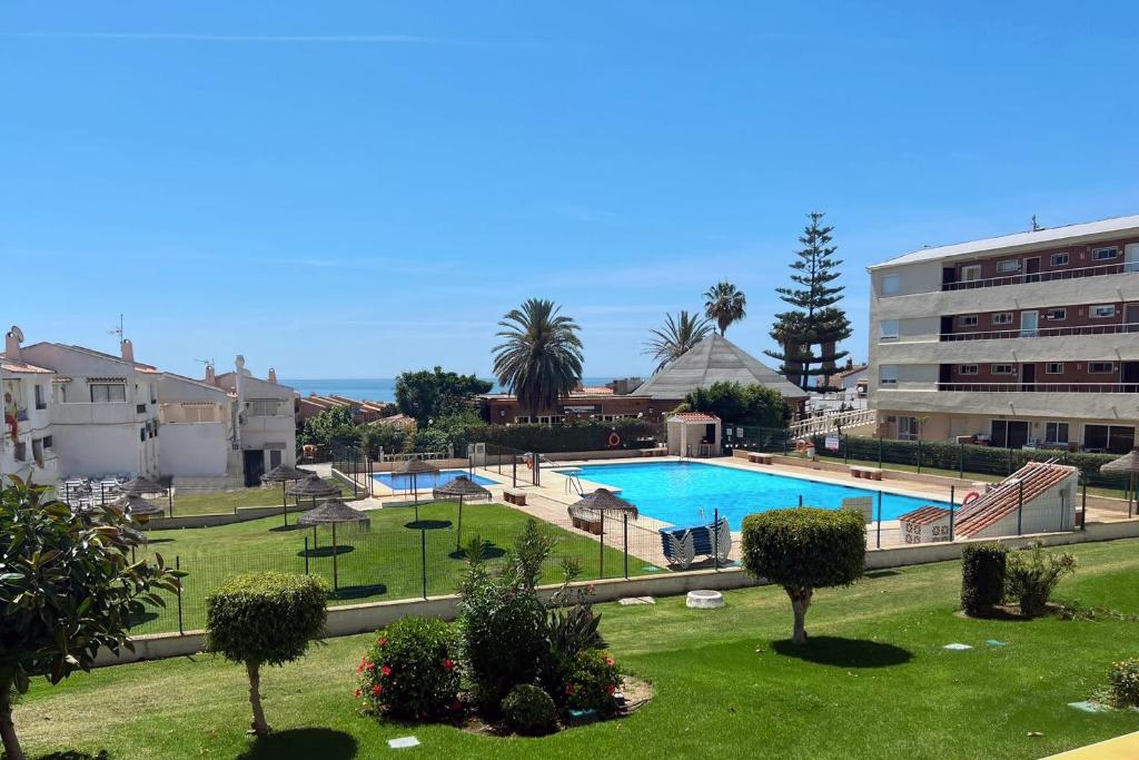a view of a swimming pool in a resort at Mijas Costa El Faro 2 Apartamento playa in Mijas