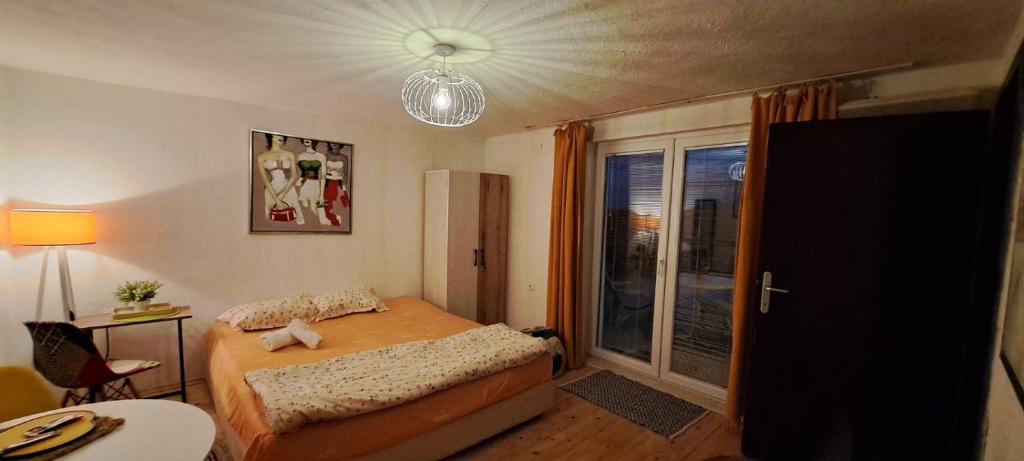 a small bedroom with a bed and a window at Hello Skopje! in Skopje
