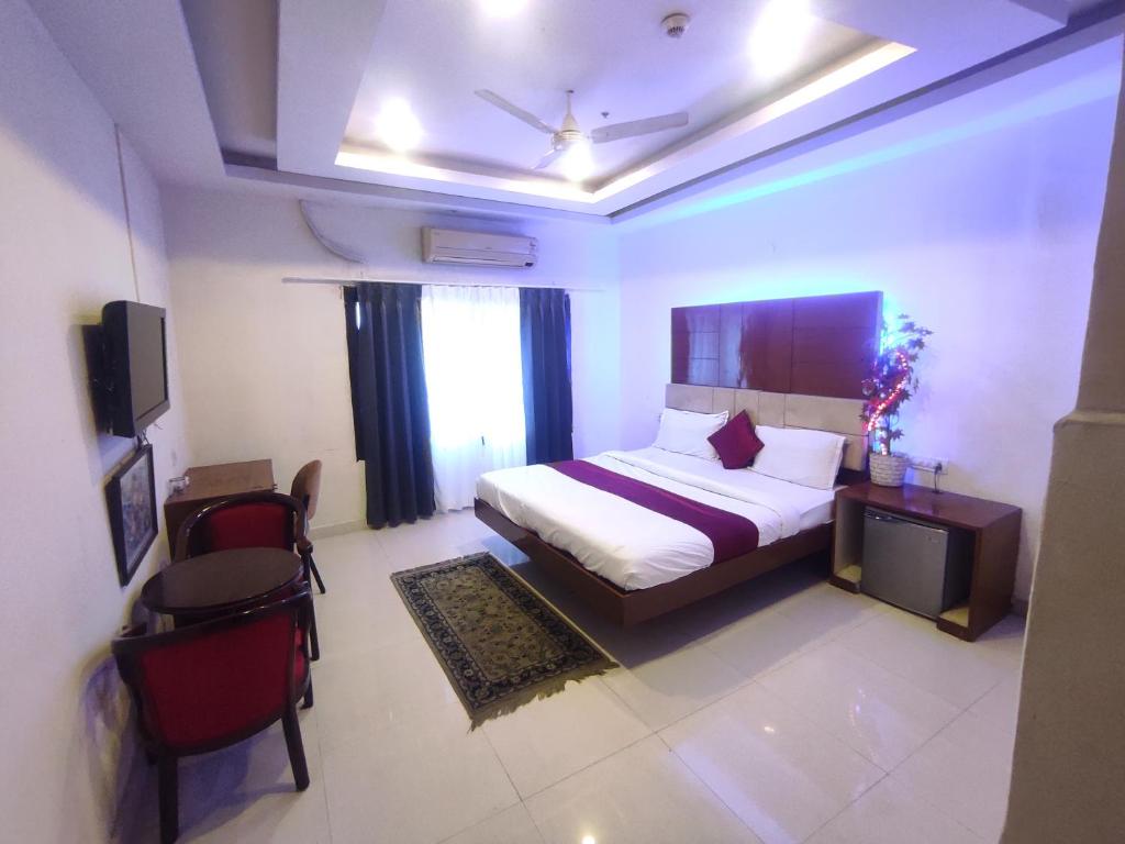 a bedroom with a bed and a television in a room at Mj birla international in Hyderabad