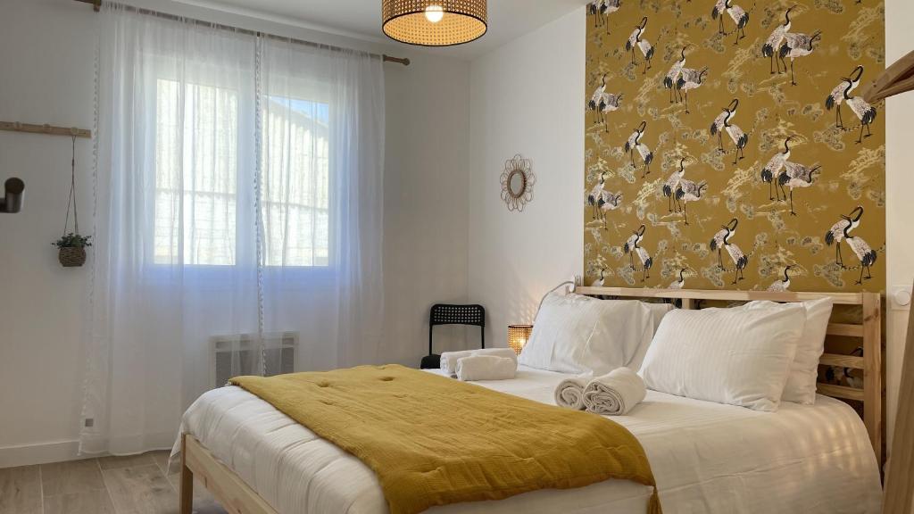 a bedroom with a large bed with a yellow blanket at Le Clos Du Moulin 3 - Maison et Jardin, proche Avignon en Provence in Entraigues-sur-la-Sorgue
