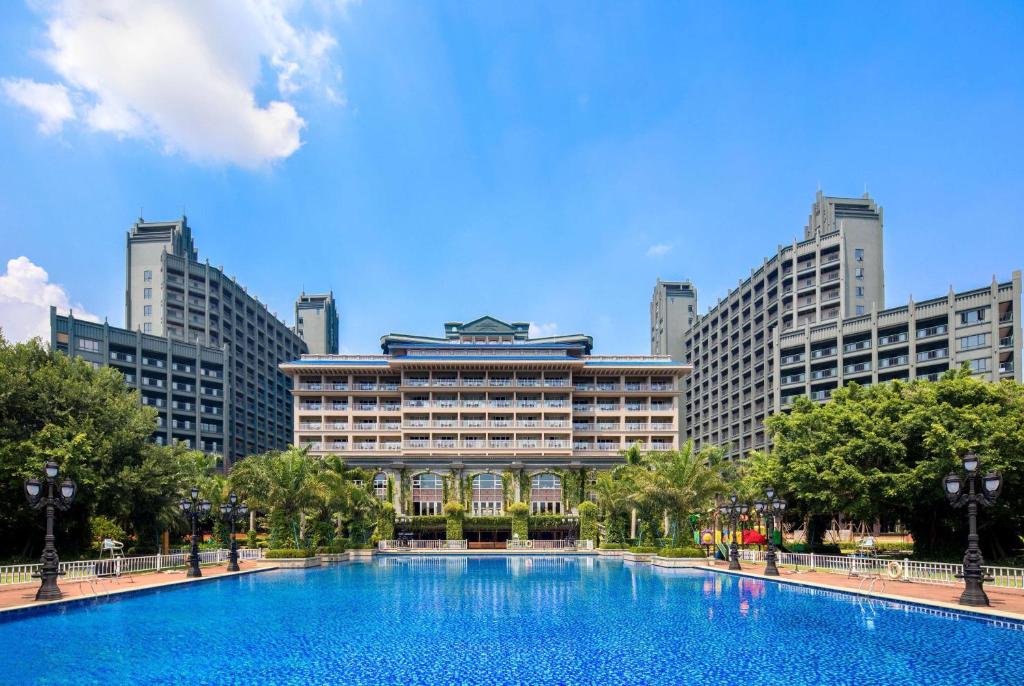 a large swimming pool in front of a building at Wyndham Garden Wenchang Nanguo in Wenchang