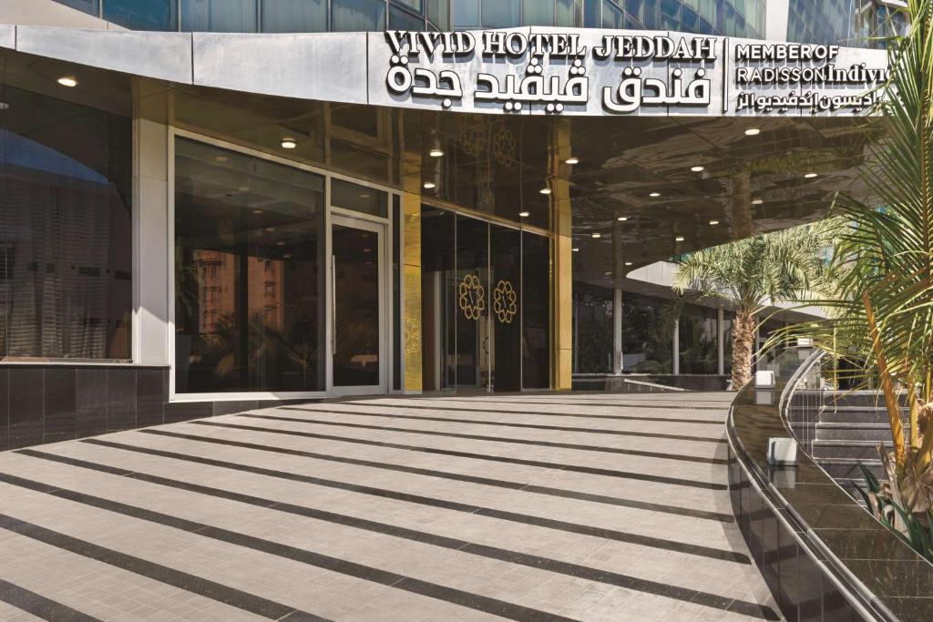 a building with a walkway in front of a building at Vivid Jeddah Hotel, a member of Radisson Individuals in Jeddah