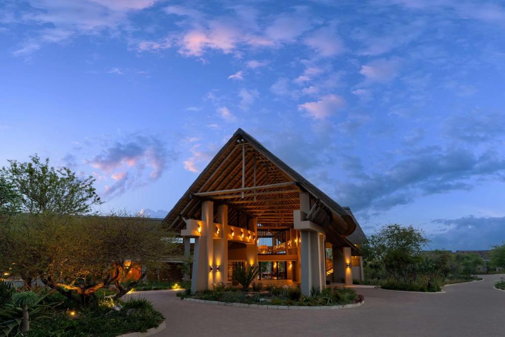 a large building with a gambrel roof at Radisson Safari Hotel Hoedspruit in Hoedspruit