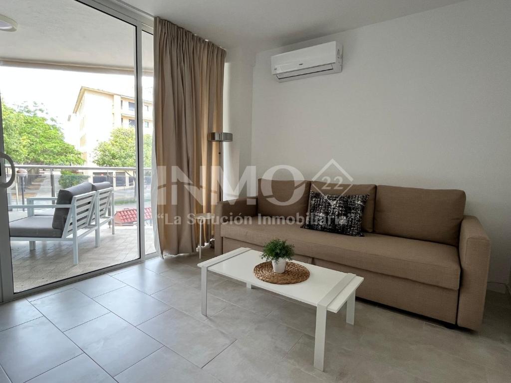 a living room with a couch and a table at Moderno apartamento a pocos metros de la playa 126A - INMO22 in Cambrils