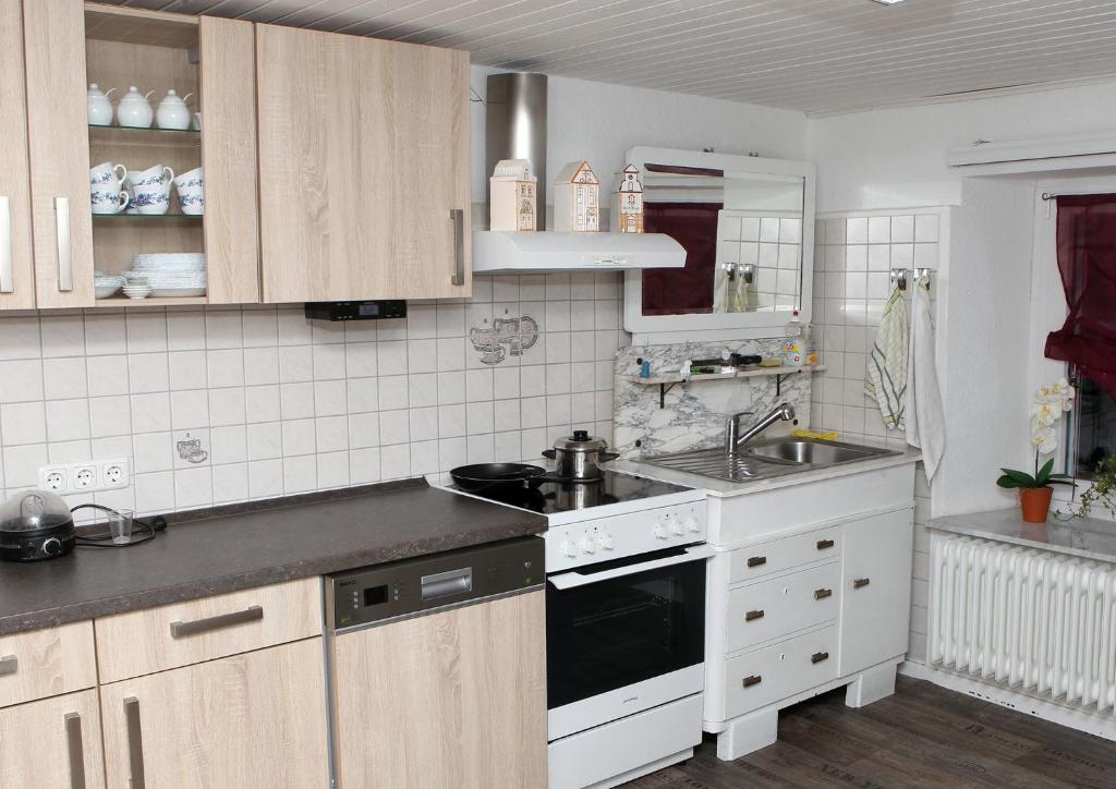 a kitchen with a sink and a stove top oven at Pension Neuenrade in Neuenrade