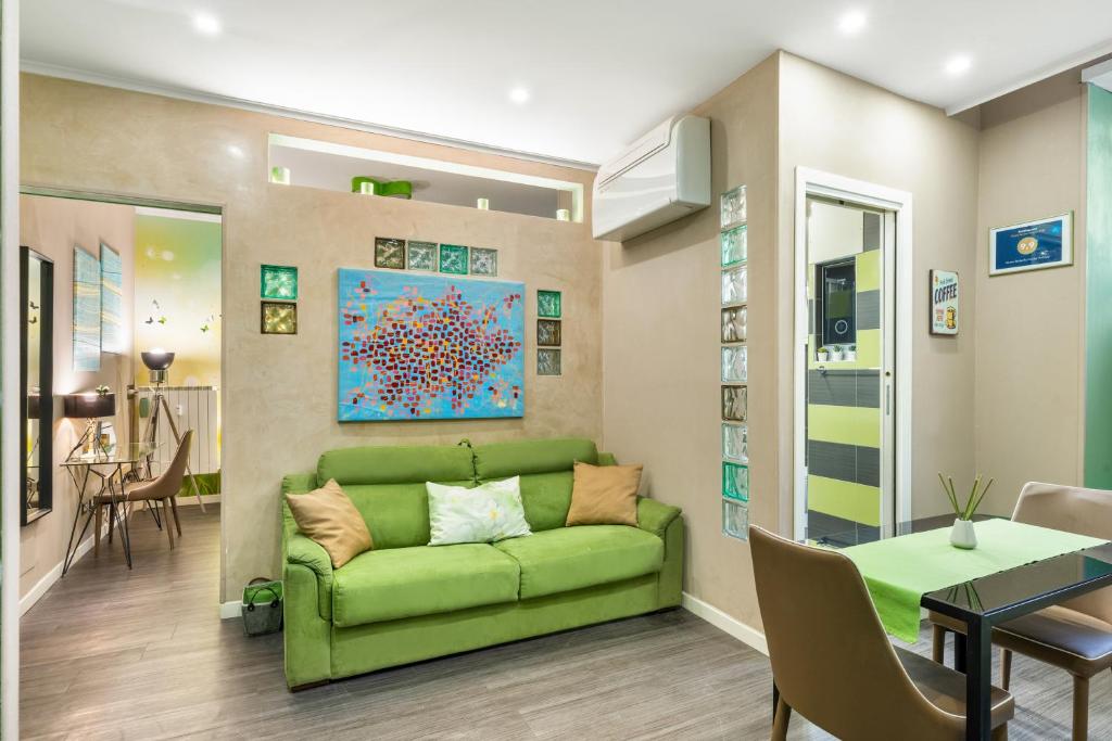 uma sala de estar com um sofá verde e uma mesa em GREEN butterfly house holiday em Roma