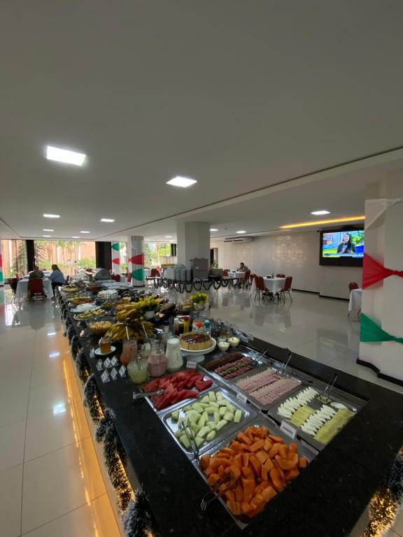 a buffet line with many different types of food at Hotel Europa in Blumenau