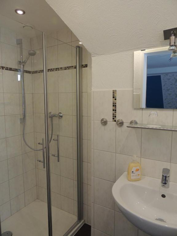 a bathroom with a shower and a sink at Pension Neuenrade in Neuenrade