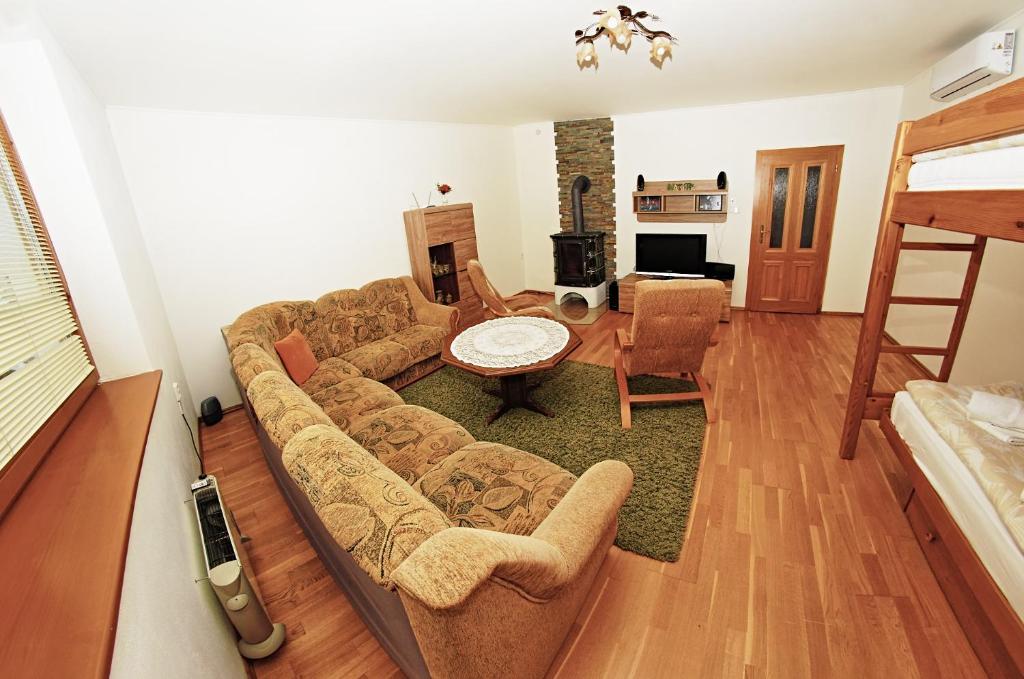 a living room with a couch and a table at Apartmany pod Tatrami in Važec