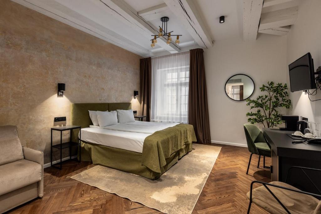 a hotel room with a bed and a desk at Konventa Sēta Hotel Keystone Collection in Rīga